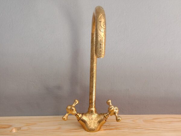 Unlacquered brass gooseneck faucet with hand-engraved detailing