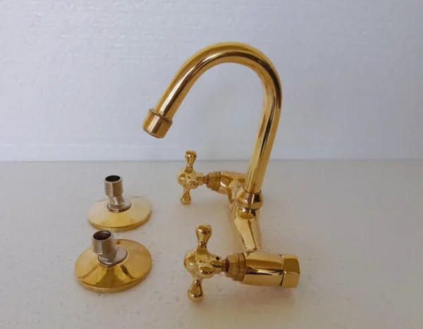 Elegant wall-mounted brass bridge kitchen faucet with traditional appeal